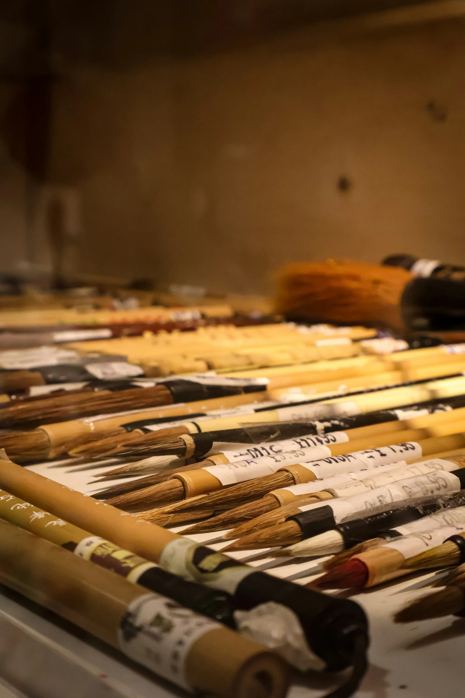 many different colored baseball bats lined up on a table