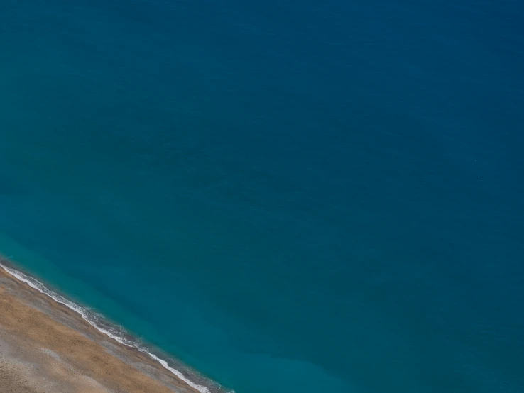 a plane is on a sandy beach in the water