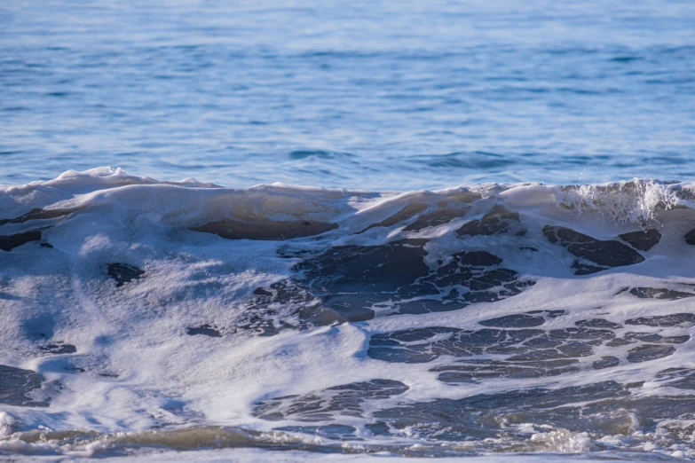 a man riding a wave on top of a surfboard