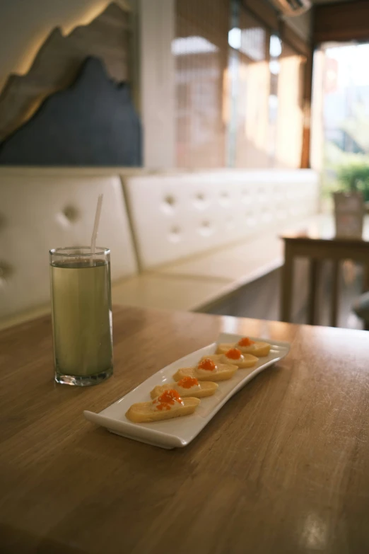 a plate of food is sitting on a table next to a glass of drink