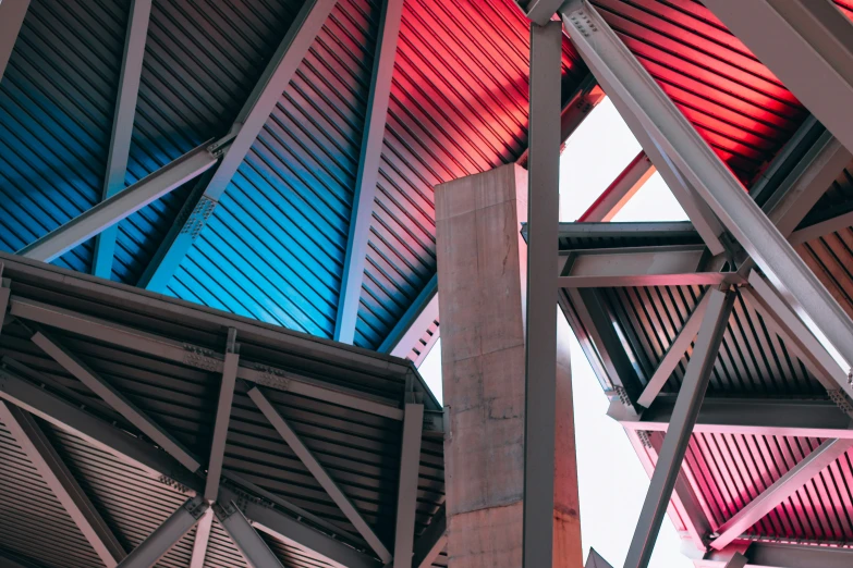 many poles are seen up in the air, with colorfully painted steel