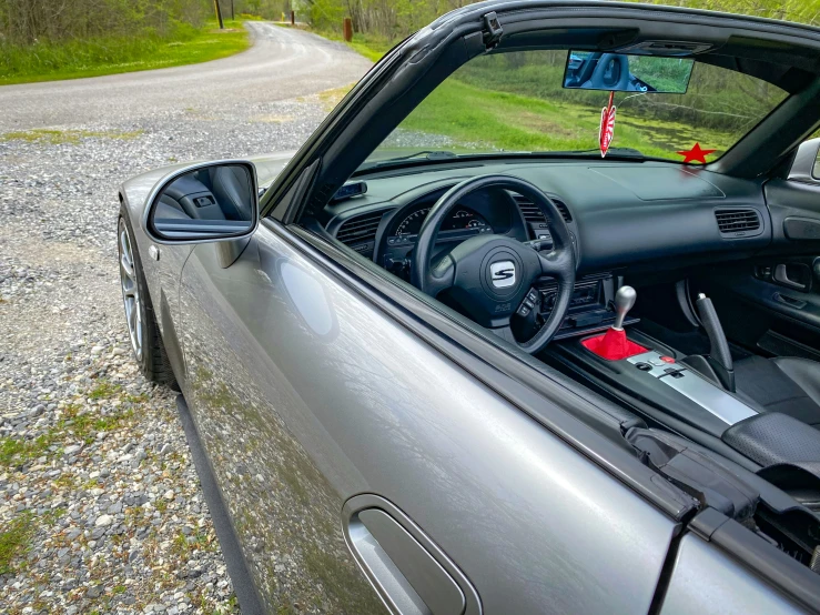 a silver car parked on the side of a rural road