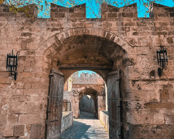 a building is shown through an archway to another building