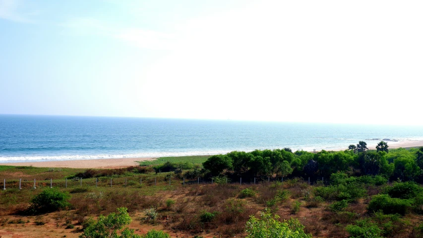a view from top of a hill overlooking the beach and ocean