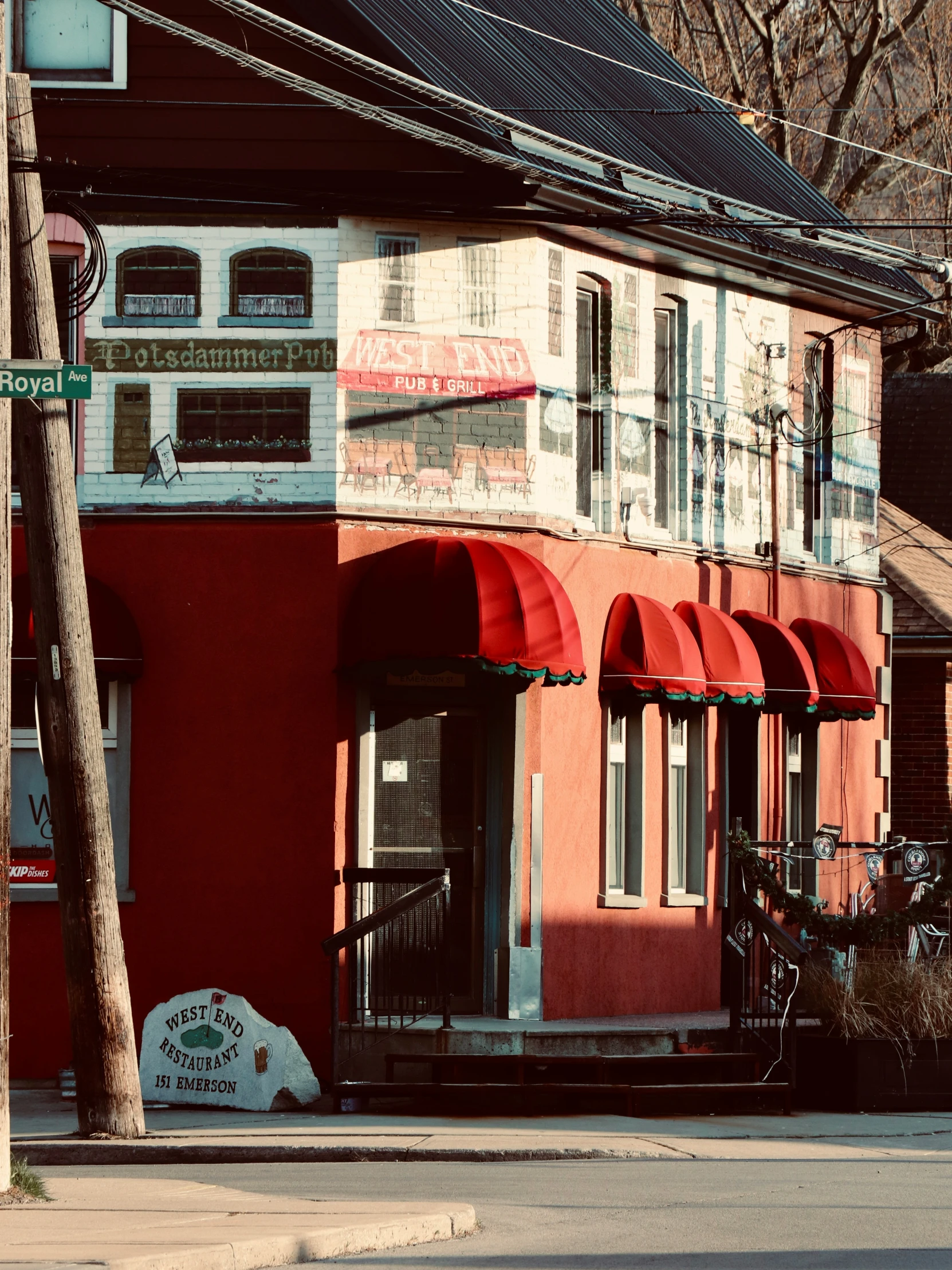 red and white business with awnings is situated on a street corner