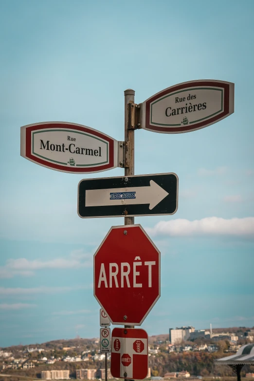 street signs and traffic signs atop a stop sign