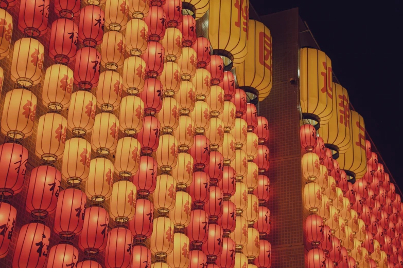 some large red and yellow lanterns next to one another