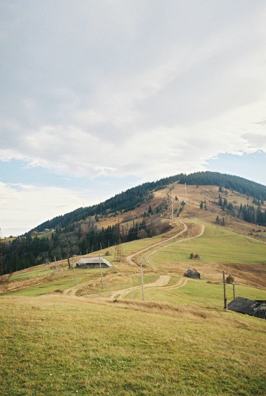 mountains are behind a grassy hillside