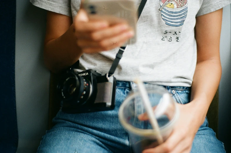 a woman in white shirt using a cell phone