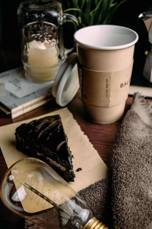 a slice of cake is next to a coffee cup