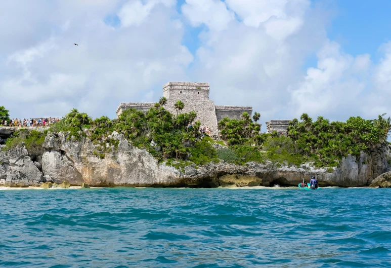 a very nice view of an old castle in a small island with many trees on the shoreline