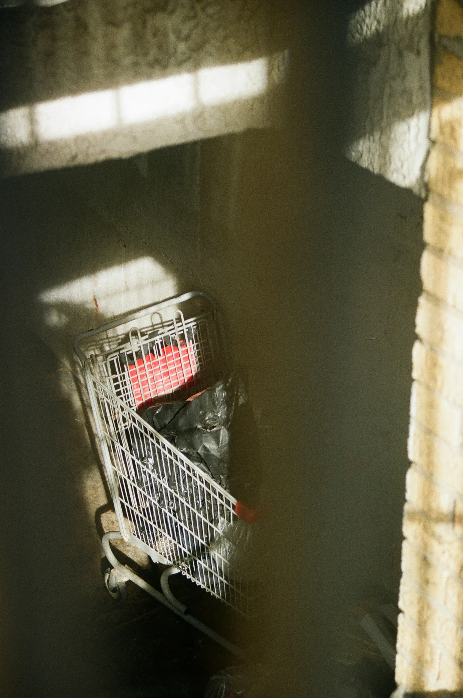 a shopping cart is seen through a small hole