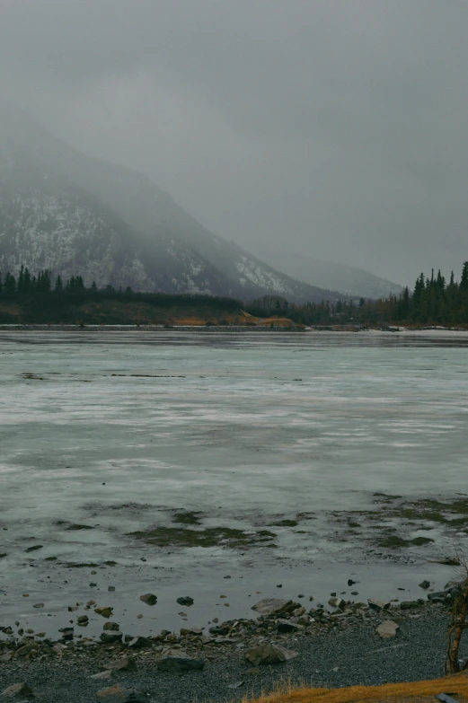 a man on a boat in the middle of an icy lake