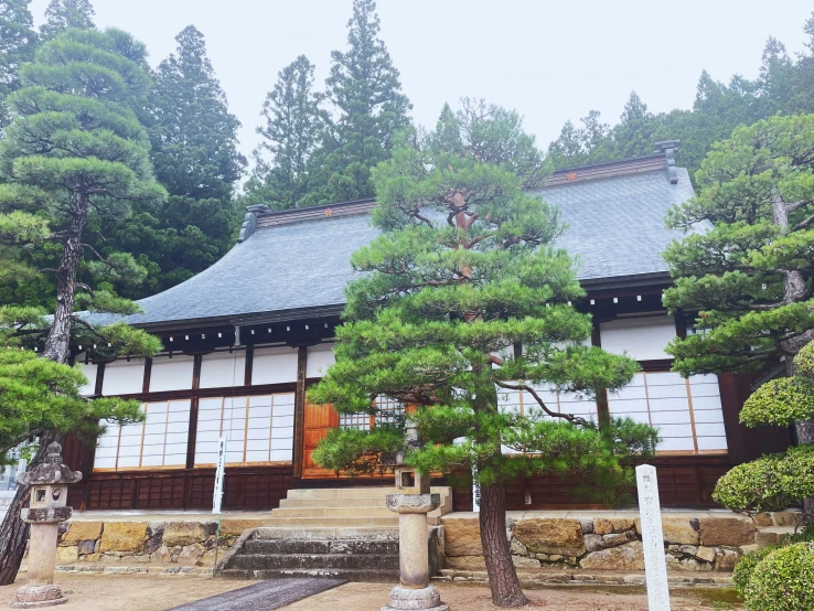 an old building with stone steps near some trees