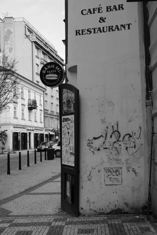 a city street corner with a coffee bar and restaurant sign