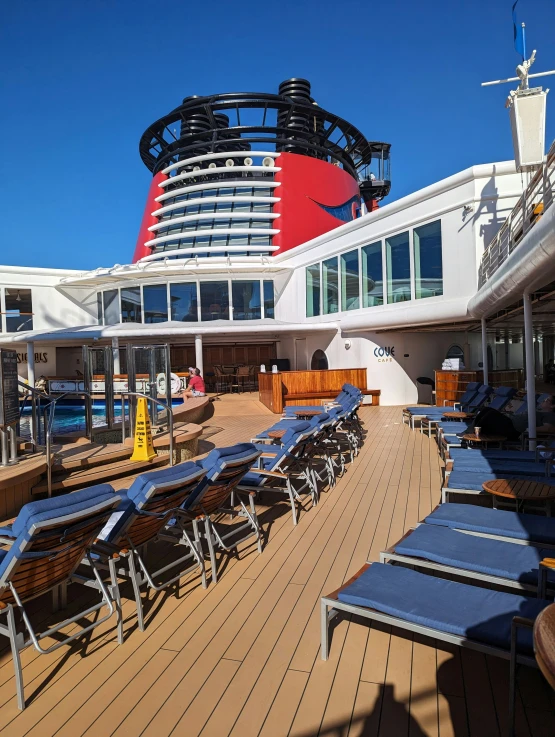 lounge chairs are lined up outside on the deck