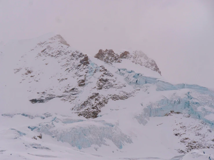 a snow covered mountain on a gray day