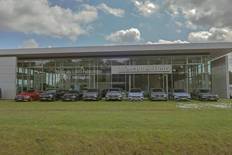 several cars parked in front of the front entrance of a large building