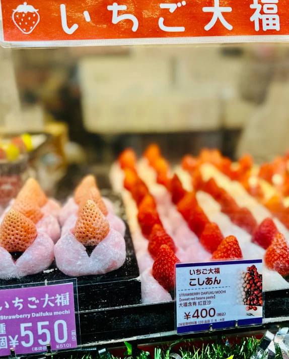 a display in a food market with strawberry cones