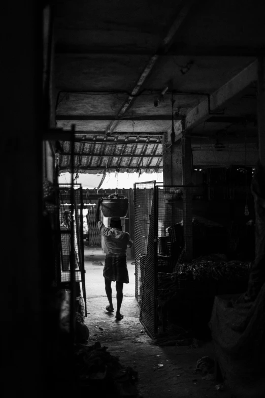 the view from inside a building with a person carrying luggage in it