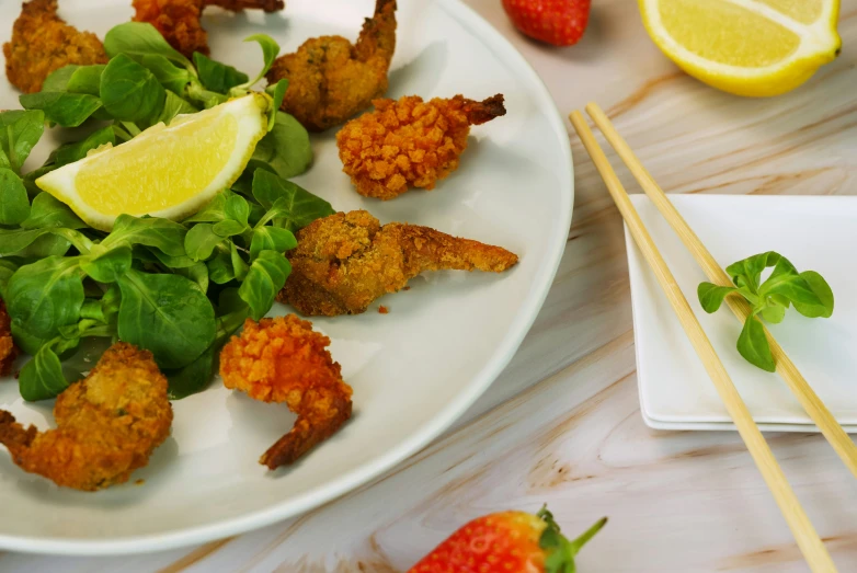 some food and chopsticks that are on a plate