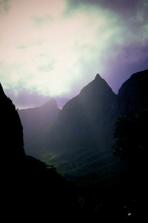 sun low on mountain range behind with clouds