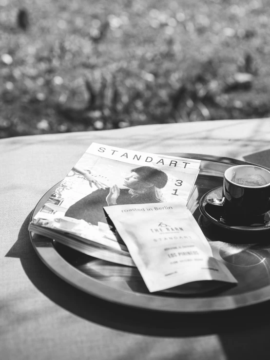 a plate with a cup and some pamphlets on it