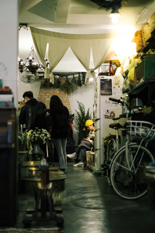 two people sitting in a room near a bike