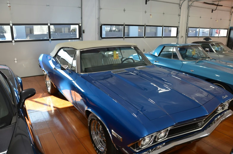 several different colored muscle cars are on display