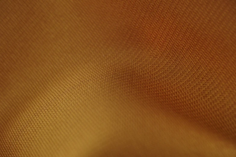 the texture of fabric is orange and golden