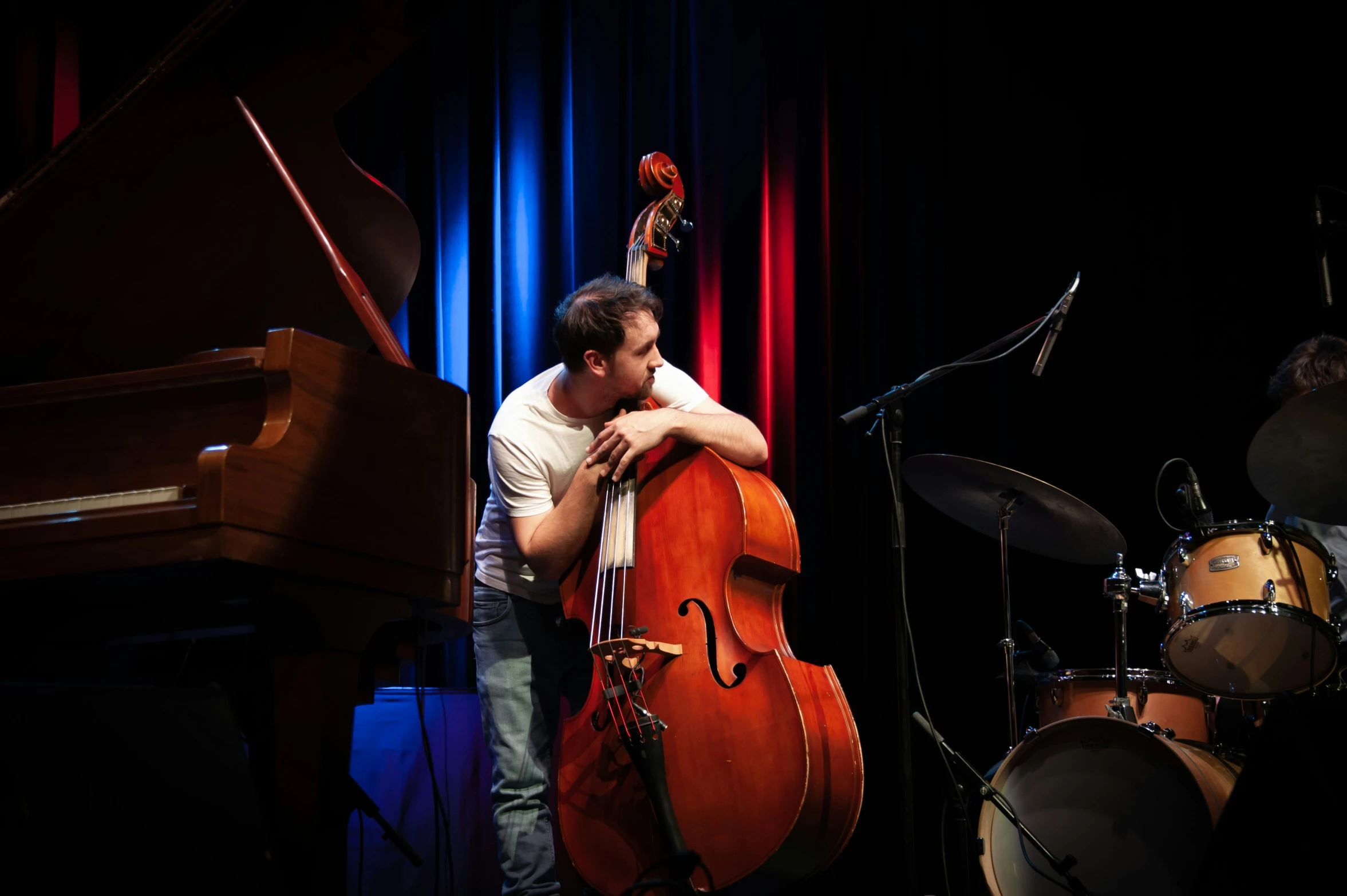 a person kissing another person while playing a instrument