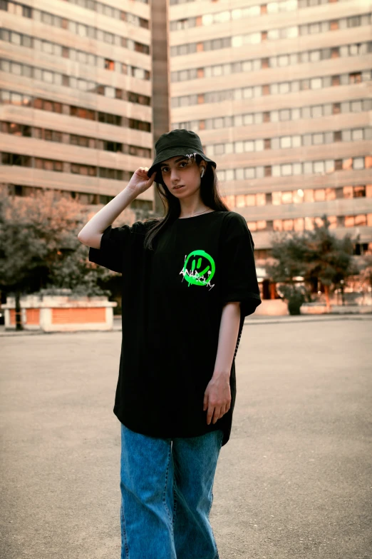 a girl with a green and black skateboard next to tall buildings