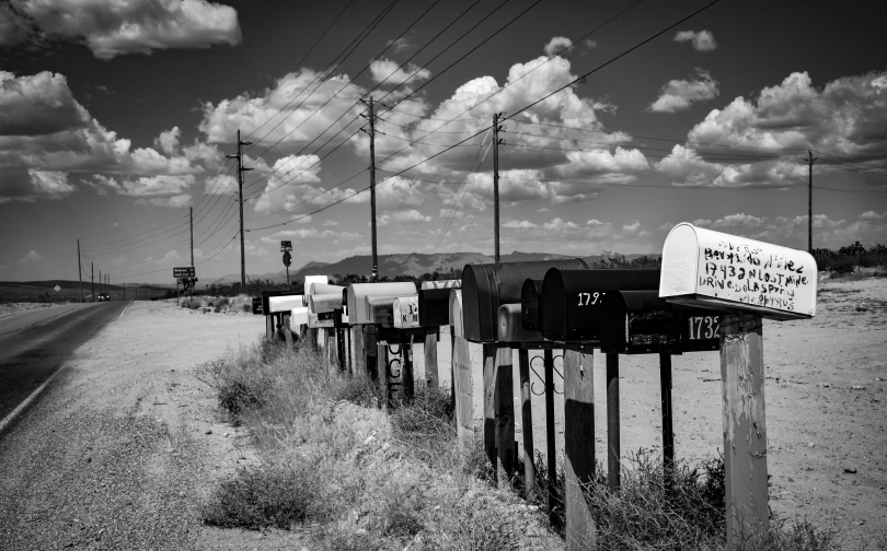 many mailboxes line up in front of a rural highway
