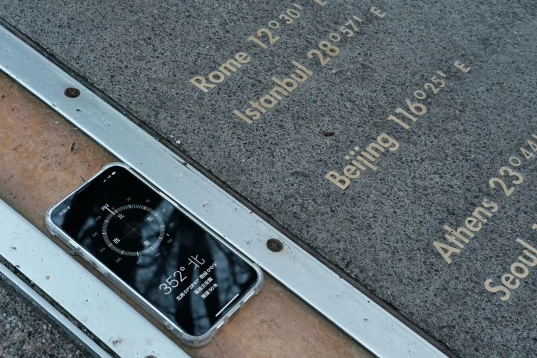 a cell phone laying down in a silver square