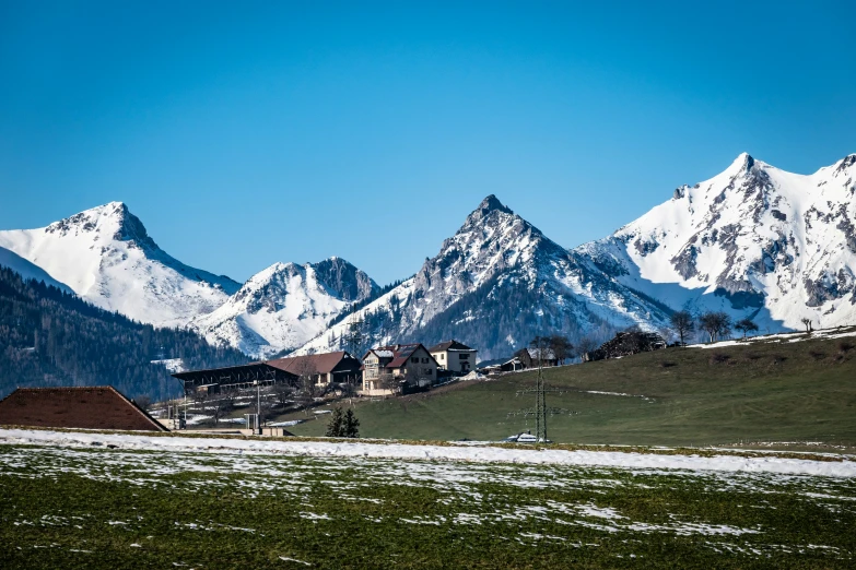 the village sits in a valley surrounded by snow capped mountains