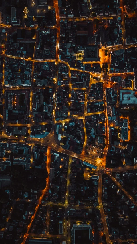 a very big city at night time, looking down on the streets