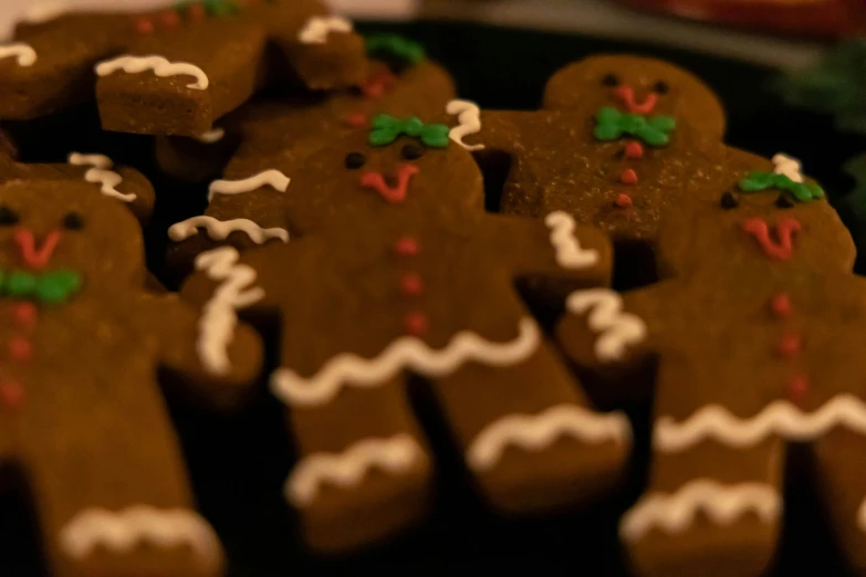 a lot of decorated gingerbreads on the counter