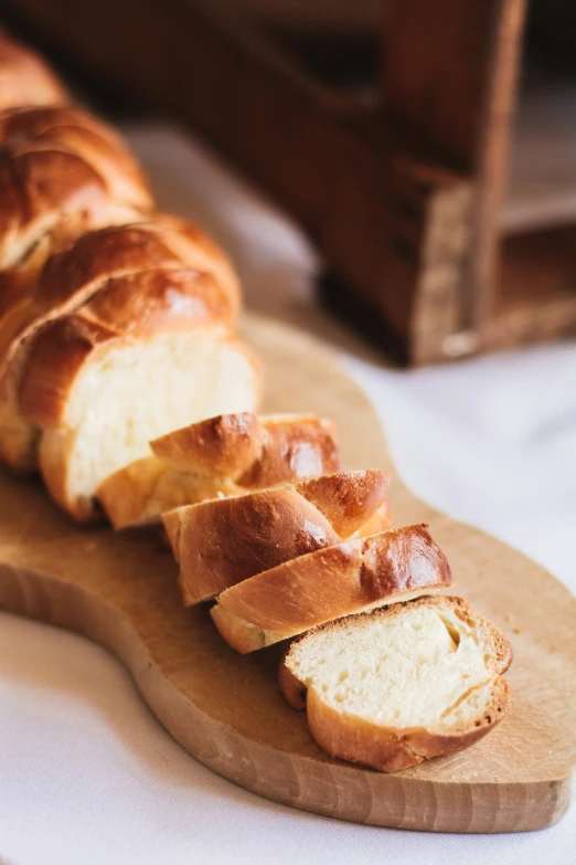 sliced bread sitting on top of a wooden  board