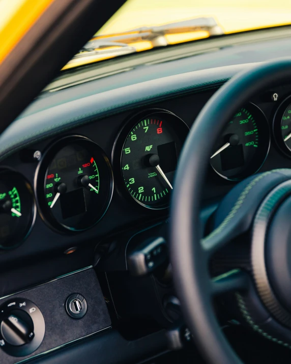 the instrument inside of an old car with a steering wheel