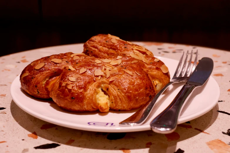 a plate with three pastries on it and a fork