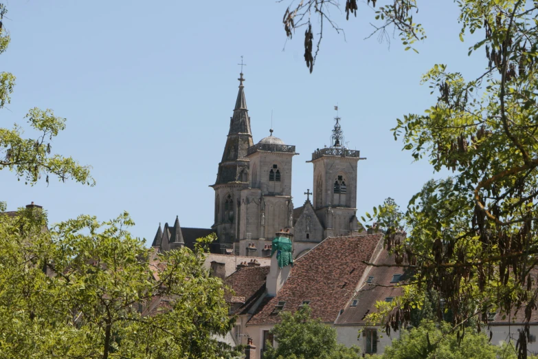 a large church on top of a hill next to some trees