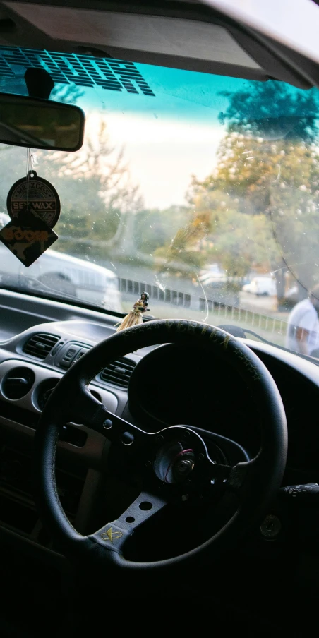 a man driving a car in front of a window