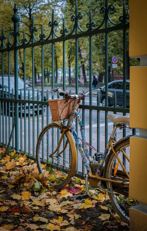 a bike locked to a fence in front of a street