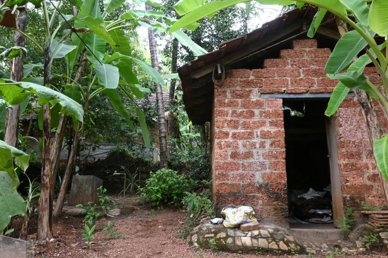 this is a small brick shack with its door open