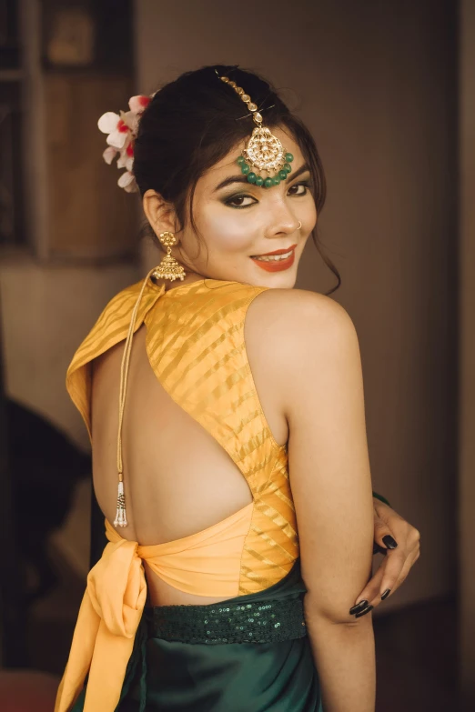 an asian woman with her back turned with a head piece