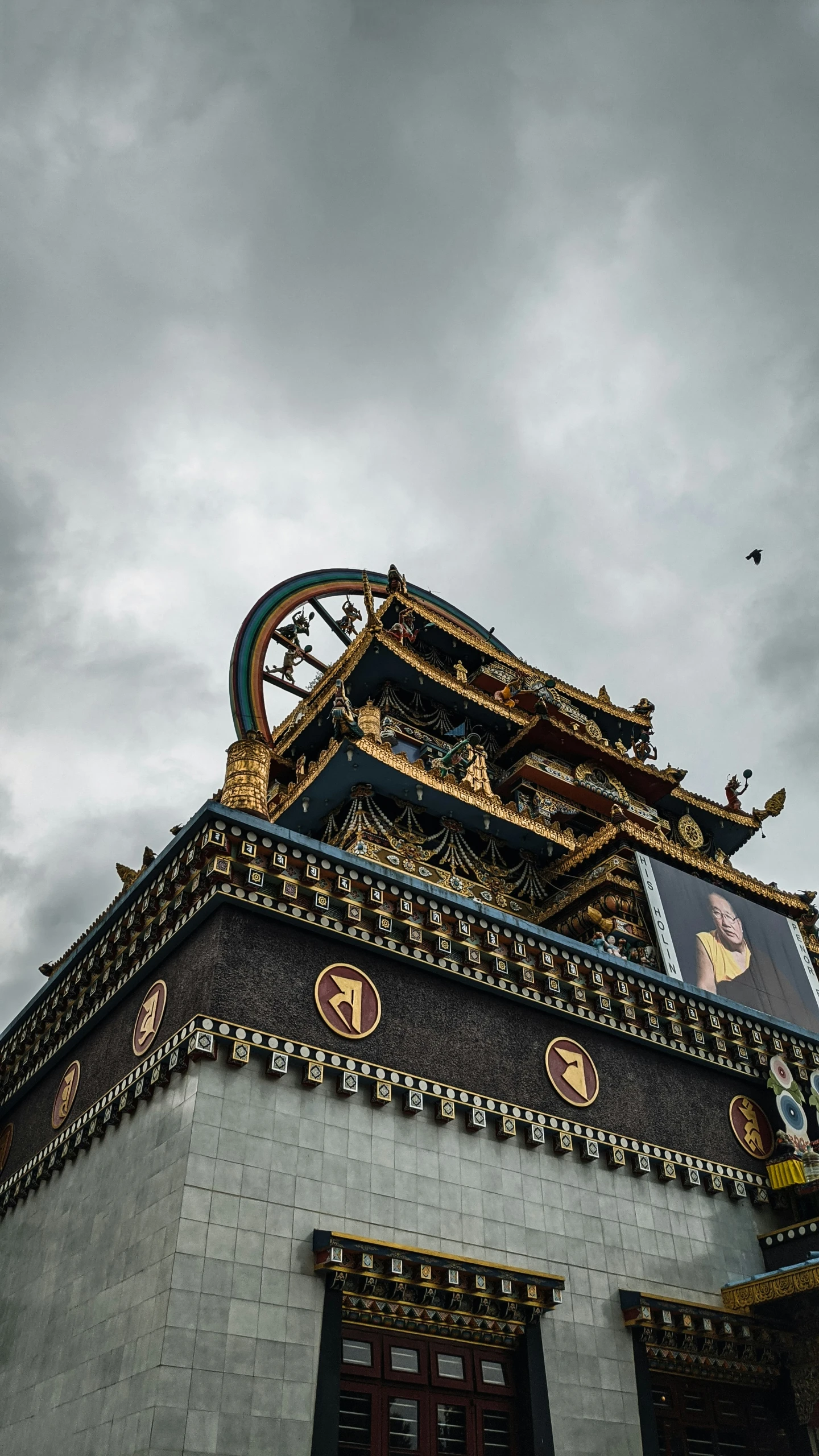 the top of an oriental building against a cloudy sky