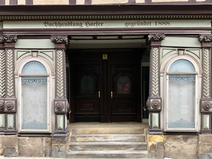 a building with a front entrance and a set of stairs leading up to the door