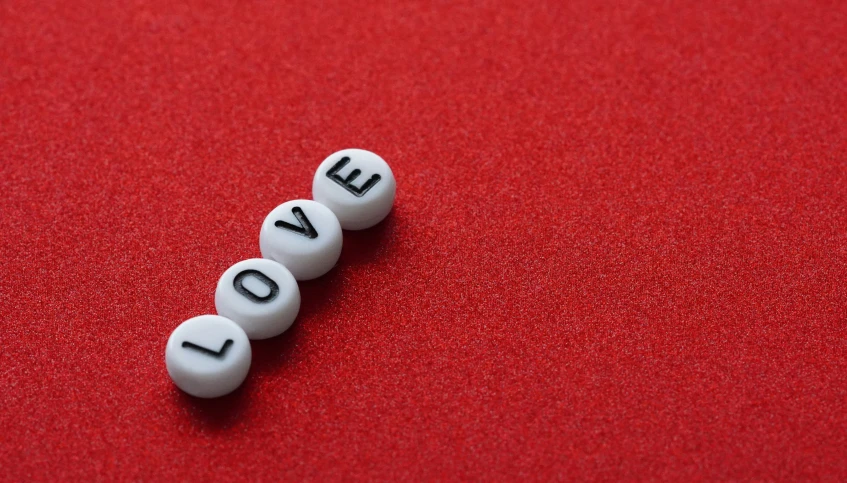 a group of love balls sitting on top of a red table