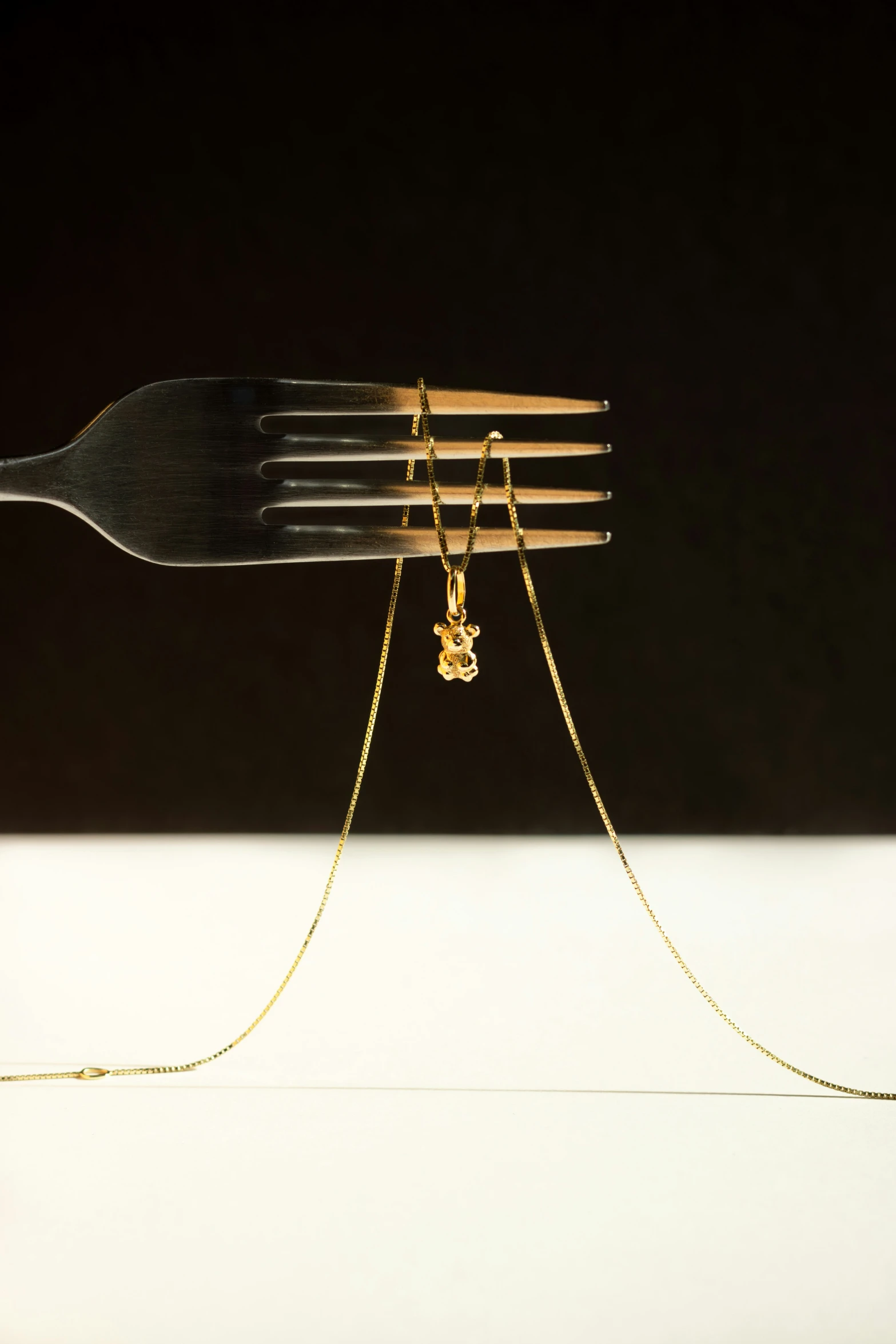 fork, metal, and chain sitting in a row on a table