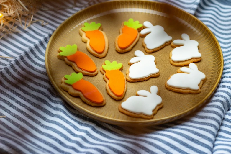 several decorated cookies arranged on a gold platter